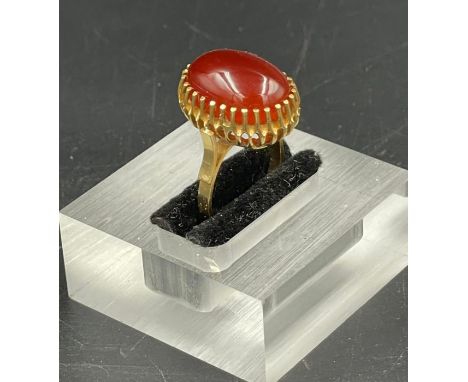 A Carnelian ring set in yellow gold marked 750. (Approximate Total Weight 8.7g) Size M