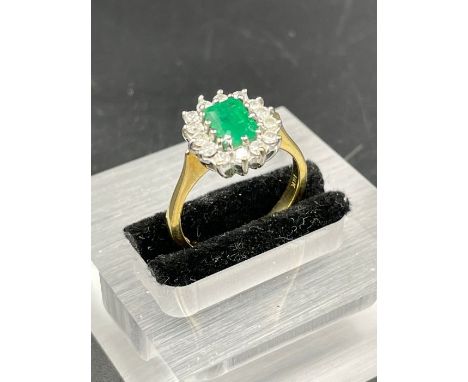 An 18ct yellow gold set emerald and diamond ring Size O