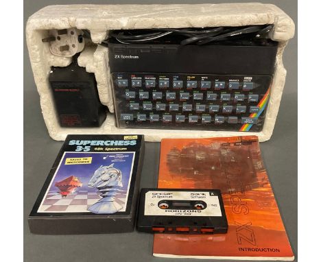 A Sinclair ZX Spectrum 8-bit home computer with Sinclair Horizons starter pack cassette and instruction manual; Another, a Su