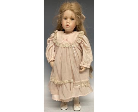 A 19th century style bisque head doll, blond hair, porcelain limbs, indistinctly signed,  51.5cm long, late 20th century