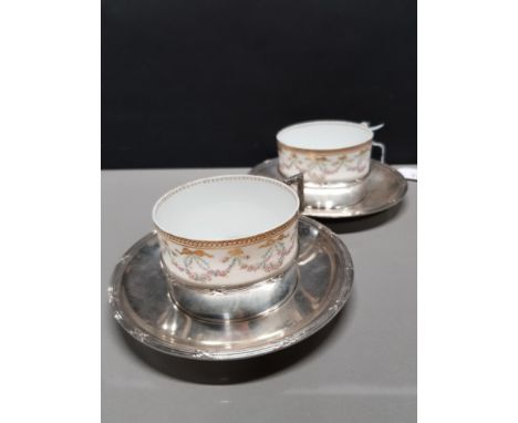 2 LIMOGES CUPS ON SILVER PLATED BASES AND WITH SAUCERS