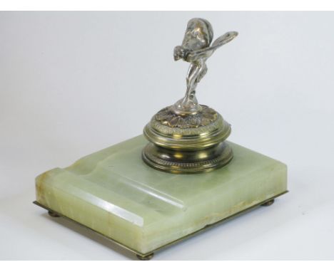 A Rolls-Royce Trade Gift.An engine-turned and decorated desk inkwell with a miniature Rolls-Royce mascot on the hinging lid, 