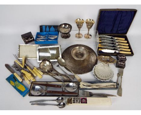 A quantity of flatware, plated and stainless, part boxed, other plated ware and two photograph frames with silver fronts.