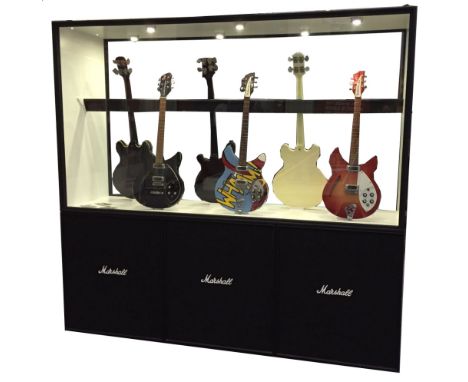 A large double sided glazed display cabinet designed as three Marshall speakers, currently used to display guitars.