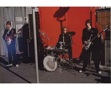 A large display panel depicting the band playing the Soho market gig.