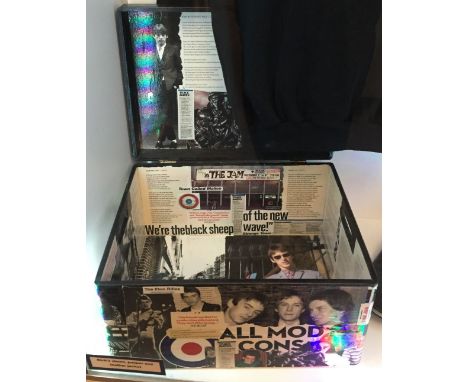 A small rectangular trunk decorated inside and out with artwork relating to the band.