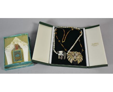 Two Necklaces with Lion and Elephant Pendants Together with a Vintage Bottle of Eau De Cologne 