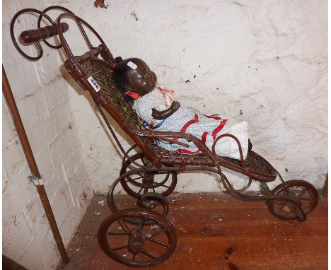 Cane and wrought iron doll's push chair together with vintage black doll