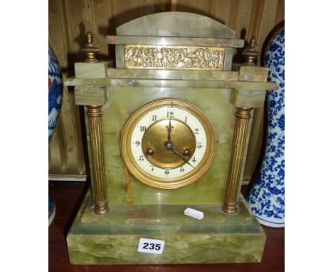 Victorian brass pillared and embellished onyx marble mantle clock, the brass dial marked Rumbold, Bridport