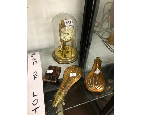 TWO COPPER POWDER FLASKS, A TORTOISESHELL CIGARETTE CASE AND A ROTARY PENDULUM CLOCK UNDER A DOME