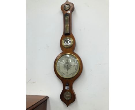 A MAHOGANY CASED WHEEL BAROMETER WITH A BRASS BEZEL ENCLOSING THE DIAL