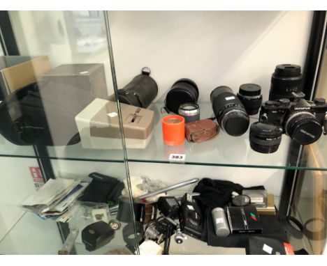 AN OLYPUS OM2 CAMERA TOGETHER WITH VARIOUS LENSES AND ACCESSORIES 