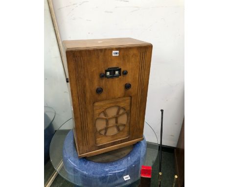 A KOSSOR RADIO IN A PLYWOOD CASE WITH A CIRCULAR CLOTH OVER THE SPEAKER OUTLET, THE CASE.   W 43 x D 26.5 x H 66cms.