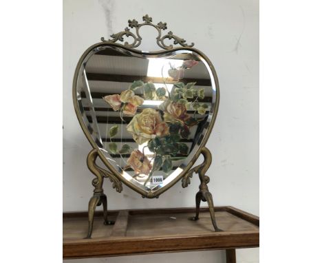 AN EARLY 20th  C. BRASS FRAMED HEART SHAPED BEVELLED GLASS FIRESCREEN PAINTED WITH ROSES
