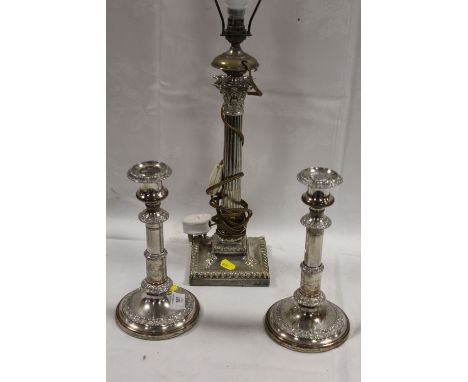 A GRECO ROMAN STYLE SILVER PLATED LAMP BASE TOGETHER WITH A PAIR OF SILVER PLATED CANDLESTICKS