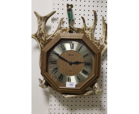 AN ANTLER MOUNTED WALL CLOCK DISPLAY