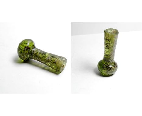 Roman Glass Urgentarium Vessel. Circa, 2nd-3rd century AD. A small green glass bottle formed of a flat bottomed spherical bas