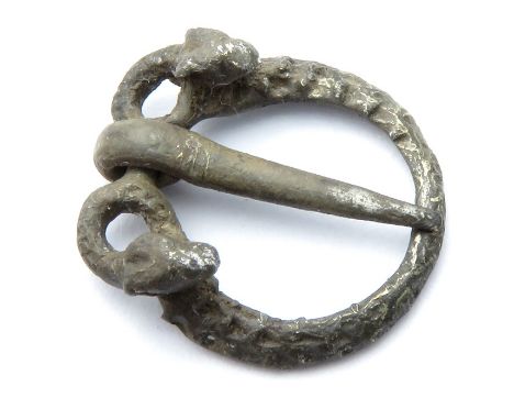 Medieval silver annular brooch, the frame is formed by two snakes, whose bodies are joined and their addorsed heads turned ba