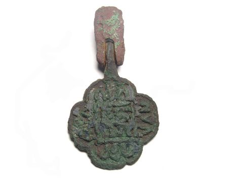 Medieval Pendant. Circa 14th century AD. Copper-alloy, 11.89g. 46.60 mm. A horse harness pendant of quatrefoil form detailed 