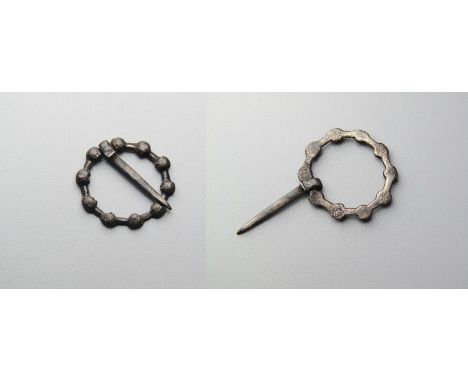 Medieval Brooch. Circa 14th century AD. Silver, 0.66g. 15.16 mm. A small finely worked annular brooch formed of ten small cro