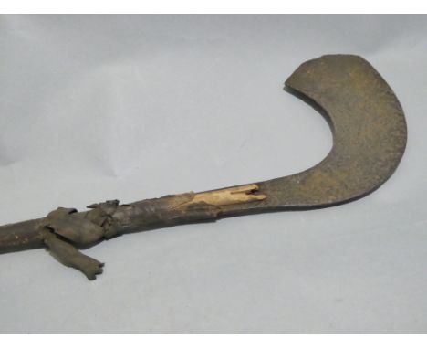 African iron curved small axe, the grip made from two bound strips of wood. Length 41.5cm. And an African steel dagger in lea