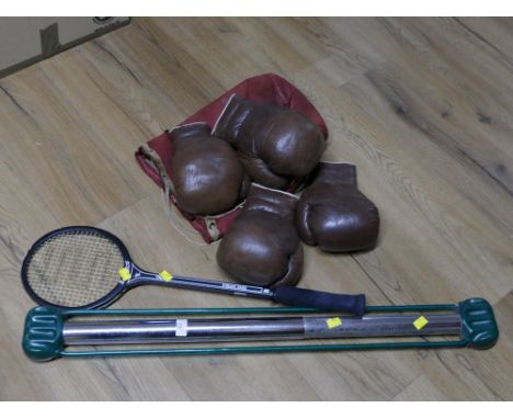 Bag of antique boxing gloves, badminton racket and bullworker