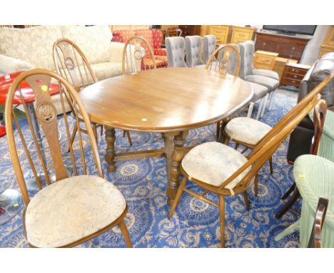 Mid stained Ercol table with 6 swan backed Ercol spindle back chairs