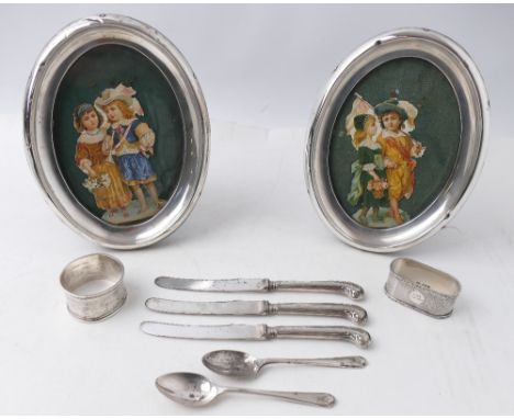 Pair of silver picture frames, 18 cm high, and silver hallmarked butter knives, spoons, napkin rings  This bladed lot is not 