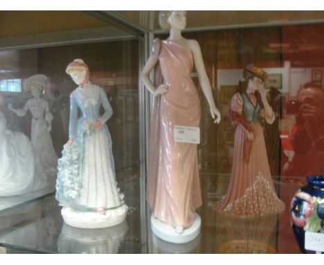 A Royal Worcester figurine; together with a Nao figurine and 'The Three Graces'