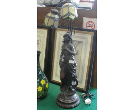 A resin lamp base depicting a woman in provocative pose