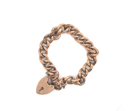 A VINTAGE OLD GOLD CHARM BRACELET COMPLETE WITH PADLOCK AND SAFETY CHAIN. THE LOCKET STAMPED 9ct B&amp;S, THE BRACELET WITH E