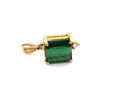 A GREEN TOURMALINE AND DIAMOND PENDANT. THE STEP CUT TOURMALINE APPROX 8 X 7mm. DROP INCLUDING ARTICULATED BAIL 1.7cms.  THE 