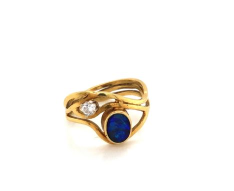 AN 18ct YELLOW GOLD HALLMARKED OPAL AND DIAMOND WAVE RING. THE OVAL OPAL TRIPET APPROX 7 x 6mm, THE CLAW SET DIAMOND APPROX 0