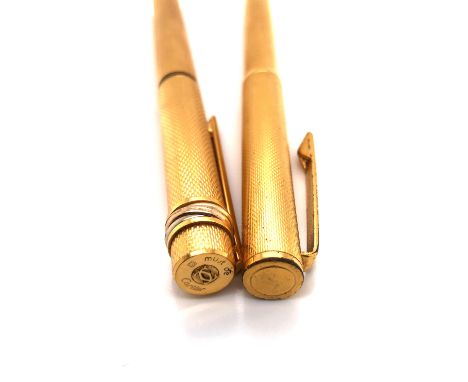 A VINTAGE CARTIER TRILOGY DESIGN GOLD PLATED FOUNTAIN PEN WITH ORIGINAL 18KT NIB, TOGETHER WITH A VINTAGE DUNHILL GOLD PLATED