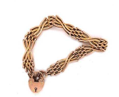 A VINTAGE ENGRAVED GATE BRACELET COMPLETE WITH PADLOCK AND SAFETY CHAIN. THE PADLOCK STAMPED 9ct, THE BRACELET UNMARKED, BOTH