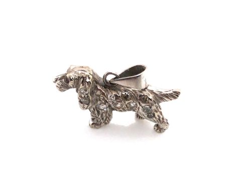 A DIAMOND SET VINTAGE SPANIEL PENDANT. THE BODY OF THE SPANIEL SET WITH ELEVEN DIAMONDS AND THE HEAD A RUBY SET EYE. STAMPED 