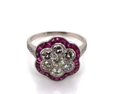 A RUBY AND DIAMOND ART DECO STYLE FLOWER CLUSTER RING. THE CENTRAL CLUSTER CONSISTING OF SEVEN OLD CUT DIAMONDS APPROX ESTIMA