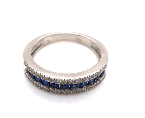 A PLATINUM HALLMARKED SAPPHIRE AND DIAMOND HALF ETERNITY RING. THE ROUND BRILLIANT SAPPHIRES IN A CHANNEL SETTING FLANKED BY 