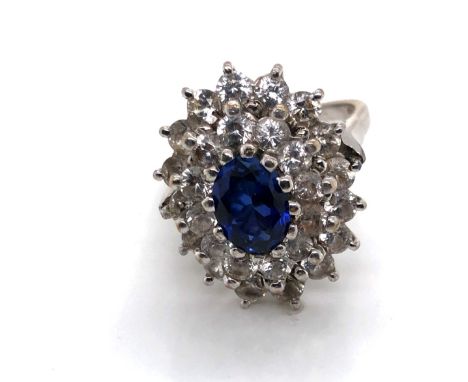 A VINTAGE 18ct WHITE GOLD HALLMARKED SAPPHIRE AND CUBIC ZIRCONIA ASCENDING DOUBLE CLUSTER RING. DATED 1975, LONDON. THE CENTR