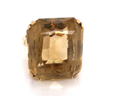 A VINTAGE CITRINE COCKTAIL RING. THE FANCY CUT CITRINE IN A RAISED DOUBLE FOUR CLAW SETTING. THE SHANK STAMPED 9ct AND ASSESS