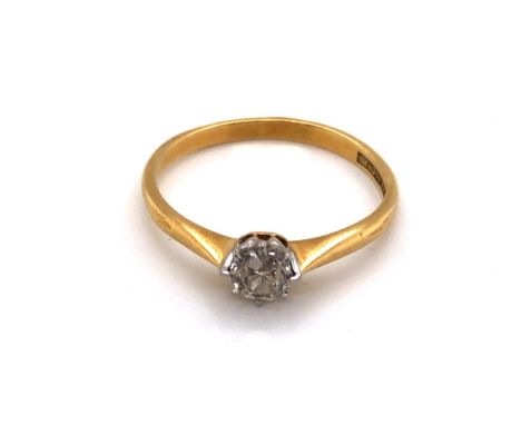 AN 18ct YELLOW GOLD AND PLATINUM SOLITAIRE DIAMOND RING. THE OLD CUT DIAMOND IN A RAISED EIGHT CLAW PLATINUM SETTING, THE YEL