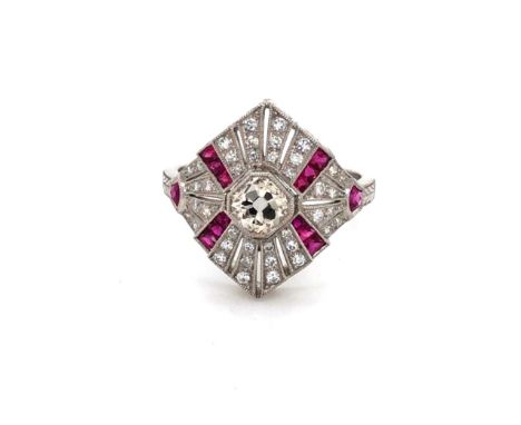 AN OLD CUT DIAMOND AND FANCY MIXED CUT RUBY ART DECO STYLE FLARED PANEL RING. THE CENTRAL DIAMOND IN AN OCTOGON SHAPED BEZEL 