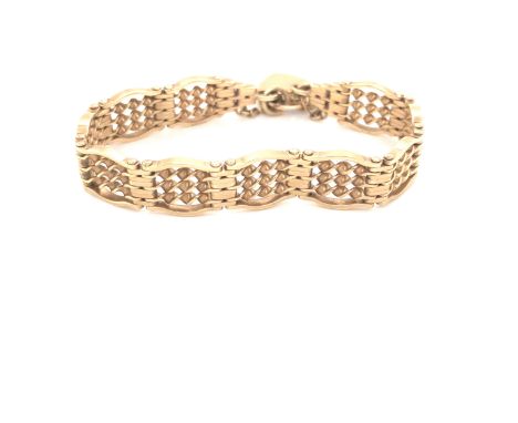 A 9ct YELLOW GOLD HALLMARKED VINTAGE TWISTED SOLID LINK FANCY GATE BRACELET COMPLETE WITH PADLOCK AND SAFETY CHAIN. WEIGHT 25