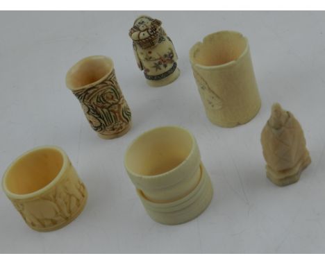A collection of carved bone napkin rings and netsuke (6)