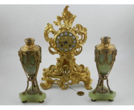 An early 20th century gilt metal mantle clock, of cast foliate form, the dial set out with Roman numerals and fitted with a F