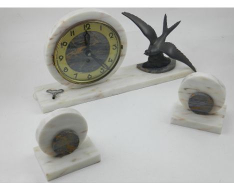 An Art Deco marble timepiece with garnitures, the clock mounted with a swift in flight, W. 40cm. 