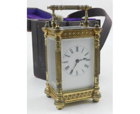 An 20th century brass carriage clock, the white enamel dial with Roman numerals, the architectural case with reeded columns a
