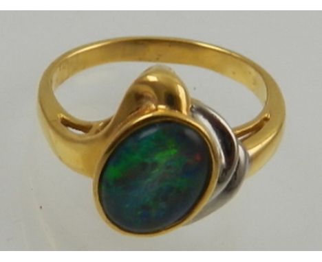 A yellow metal and doublet opal ring. 