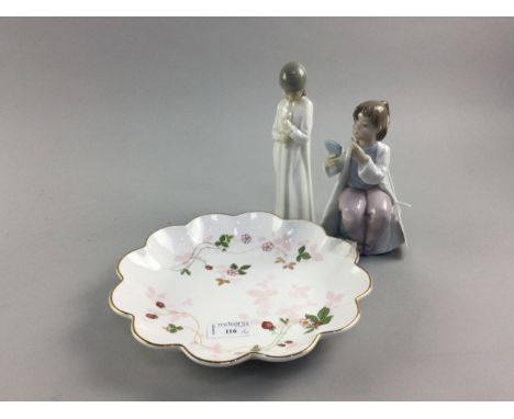 TWO NAO FIGURES OF CHILDREN, one holding a candle, the other applying lipstick, along with a Wedgwood plate with strawberry d