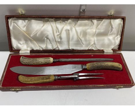 A vintage horn handled carving set